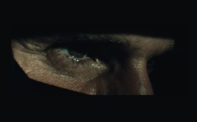 Closeup of a professional track drivers face with a black shadow. 