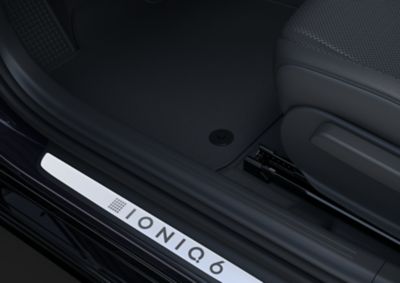 Hyundai IONIQ 6 Black Edition floor mats and stainless steel door scuff plates.