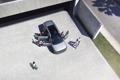 Top view of the IONIQ 9 with 6 people getting out of the car.