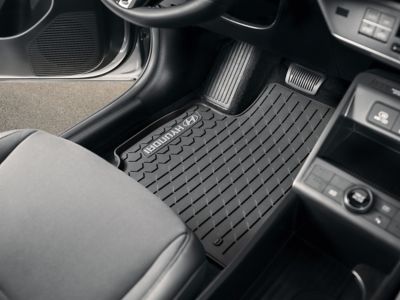 Floor mat in the cabin below the steering wheel.