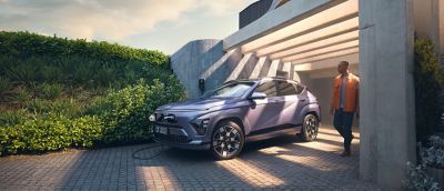Hyundai KONA Electric wide exterior shot near a scenic landscape.