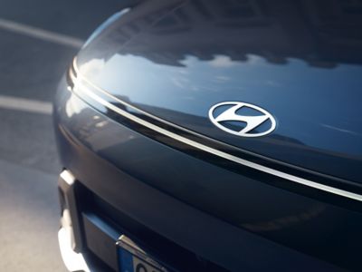 Hyundai Kona close-up view of the front fascia with logo and lighting details.