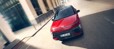 Hyundai Kona N Line wide front view driving in a city environment.