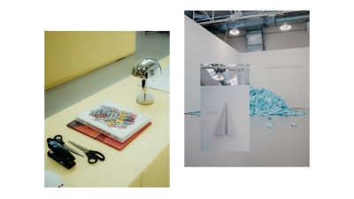 Design display with desk objects and paper art installation indoors