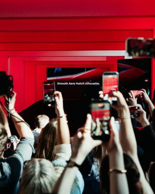 Visitors recording Hyundai installation reveal with car silhouette at Milan Design Week