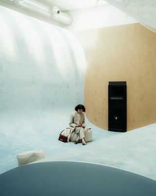 Person seated in Hyundai exhibition space engaging with installation at Milan Design Week