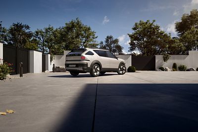 Hyundai NEXO SUV parked on a driveway with greenery and a blue sky in the background.