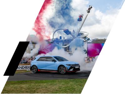 The all-electric Hyundai IONIQ 5 N doing a donut with smoke billowing from tyres.