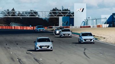 Image showing three Hyundai IONIQ 3 on a racetrack.