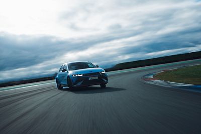 Hyundai IONIQ 5 N high-performance electric sedan drifting through a curve on a race track.