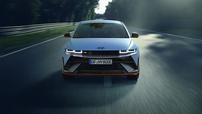 Hyundai IONIQ 5 N high-performance electric sedan show from front on a race track.