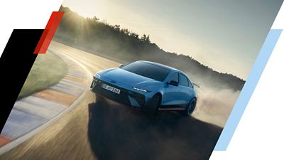 Hyundai IONIQ 6 N seen driving around a racetrack corner from the front. 