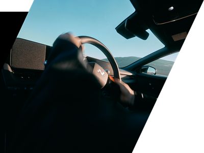 Driver gripping the leather N steering wheel inside the Hyundai IONIQ 5 N. 