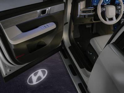 Hyundai logo projected on floor from car door light on the Hyundai SANTA FE.