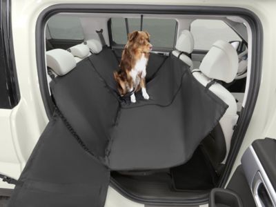 Dog sitting in the back seat pet hammock fitting between the front and back seats of the SANTA FE.