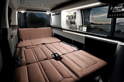Interior view of the Hyundai STARIA Camper Concept with the rear seats folded down as a bed.
