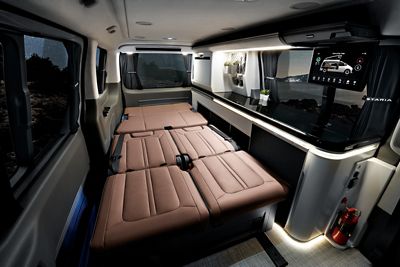 Interior view of the Hyundai STARIA Camper Concept showing the bed and kitchen area.
