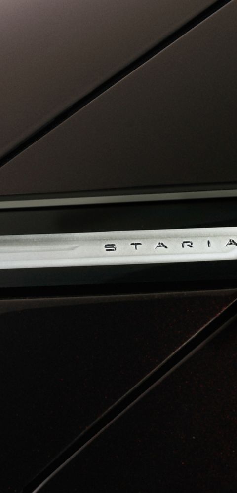 Close-up of the STARIA badge on the STARIA Electric exterior, emphasizing its futuristic branding.