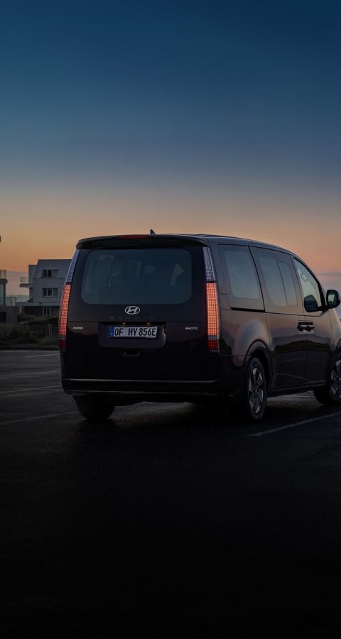 Hyundai Staria Electric rear view at sunset.