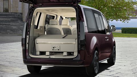 Rear view of the Hyundai STARIA Electric with open tailgate, highlighting spacious cargo space and folded seats.
