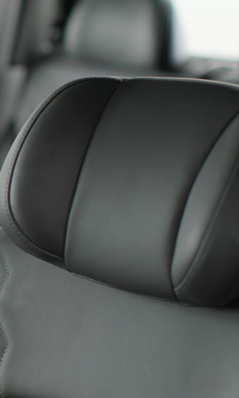 Detail view of a premium headrest inside the STARIA Electric, showing refined stitching and comfort.