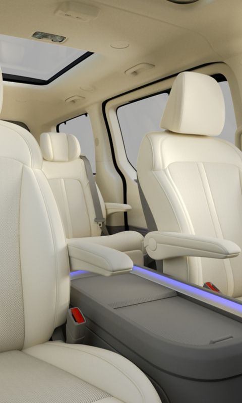 Rear seating in the Hyundai STARIA Electric featuring individual seats, armrests, and panoramic roof.