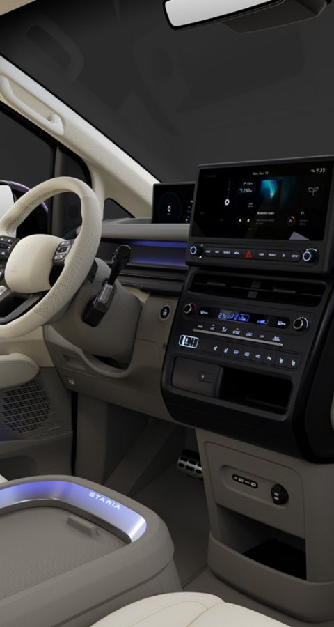 Hyundai STARIA Electric front interior with horizontal dashboard design, ambient lighting, and infotainment display.