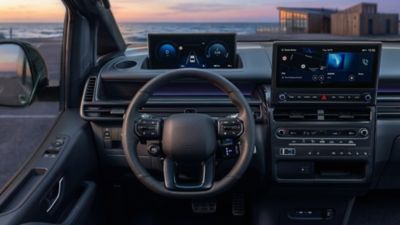 Hyundai STARIA Electric dashboard showcasing dual screens and a steering wheel.