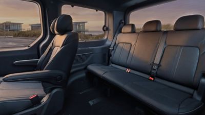 Hyundai STARIA Electric rear seating area featuring a three-person bench and single seat.