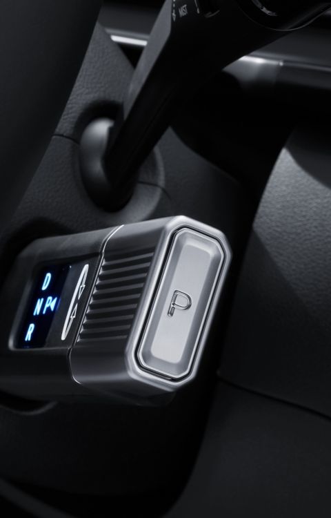 Close-up of the Hyundai STARIA Electric column-type Shift-by-Wire selector with illuminated gear display and integrated Park button