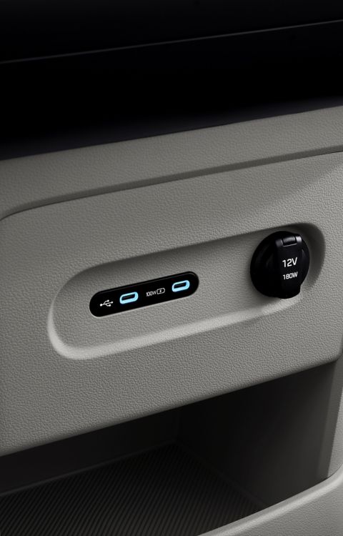 Rear cabin of the Hyundai STARIA Electric with integrated USB ports and 12V outlet for passenger convenience.