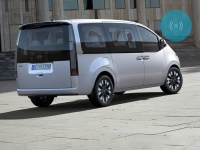 The Hyundai STARIA Hybrid Van seen from the side and rear.