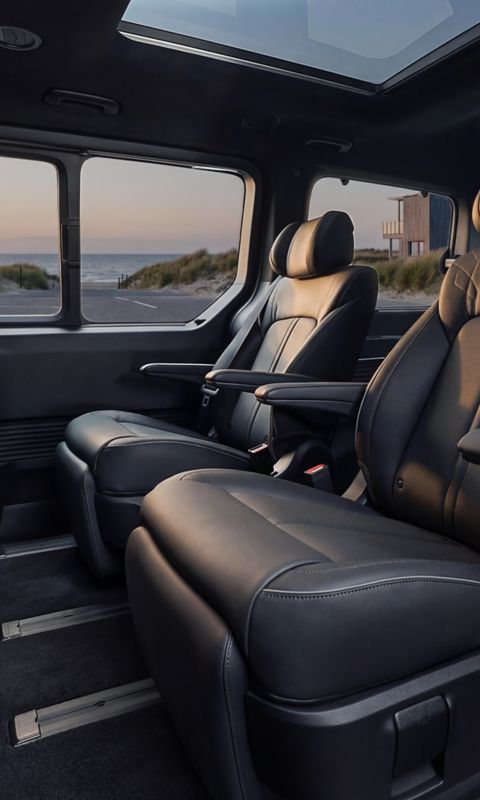 Hyundai STARIA Electric second-row leather seats with armrests and panoramic view.