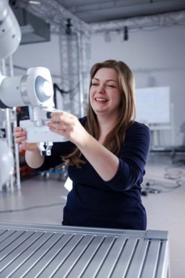 Anna Adamczyk examining a robot.