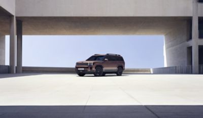 The Hyundai Santa Fe Hybrid parked near a modern building.