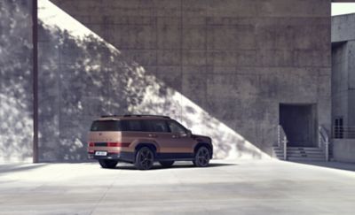 The Hyundai SANTA FE parked in front of a modern concrete building.