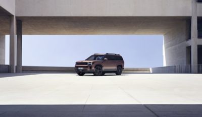 The Hyundai Santa Fe Hybrid parked near a modern building.