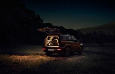 Nočný pohľad na Hyundai Santa Fe osvetlený zvnútra.