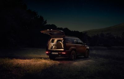 The Hyundai Santa Fe shown at night illuminated from the inside.