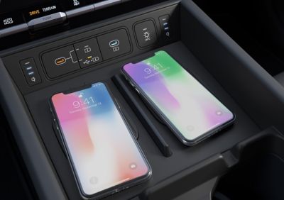 The center console with dual smartphone wireless charging pad in the Hyundai Santa Fe. 