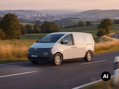 Hyundai STARIA Cargo electric driving down the street in a rural area.