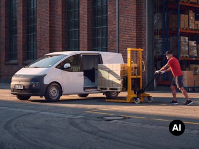 Hyundai STARIA Cargo electric being loaded with palletized boxes outside a warehouse