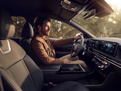 Interior view of the Hyundai TUCSON Plug-in Hybrid with a driver at the wheel