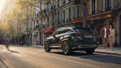 The Hyundai TUCSON Plug-in Hybrid driving on the street.