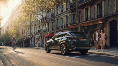 The Hyundai TUCSON Plug-in Hybrid driving on the road. 