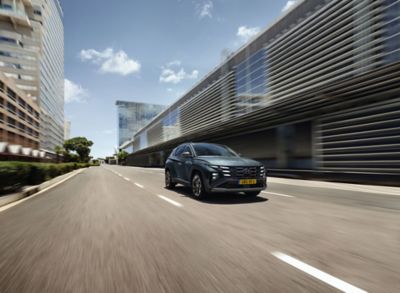 The Hyundai TUCSON Plug-in Hybrid driving on the road. 