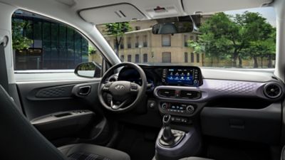 Inside view of the Hyundai i10's cockpit and convenient storage spaces. 
