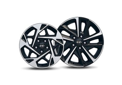 Two different Hyundai-branded alloy wheels side by side, cut out on white background.