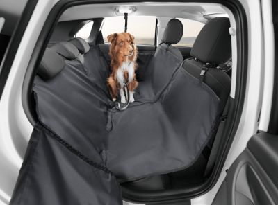 The rear seat protector for the i30 Fastback with a dog sitting on it.