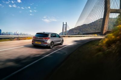 A Hyundai i20 being driven on a road, near a bridge.